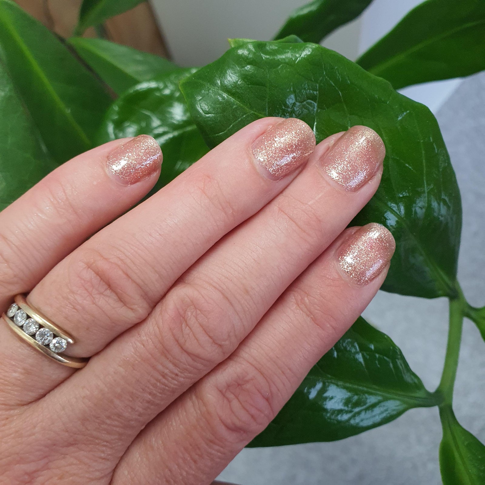 Gold gel nail polish on natural nails. Gold gel polish manicure.