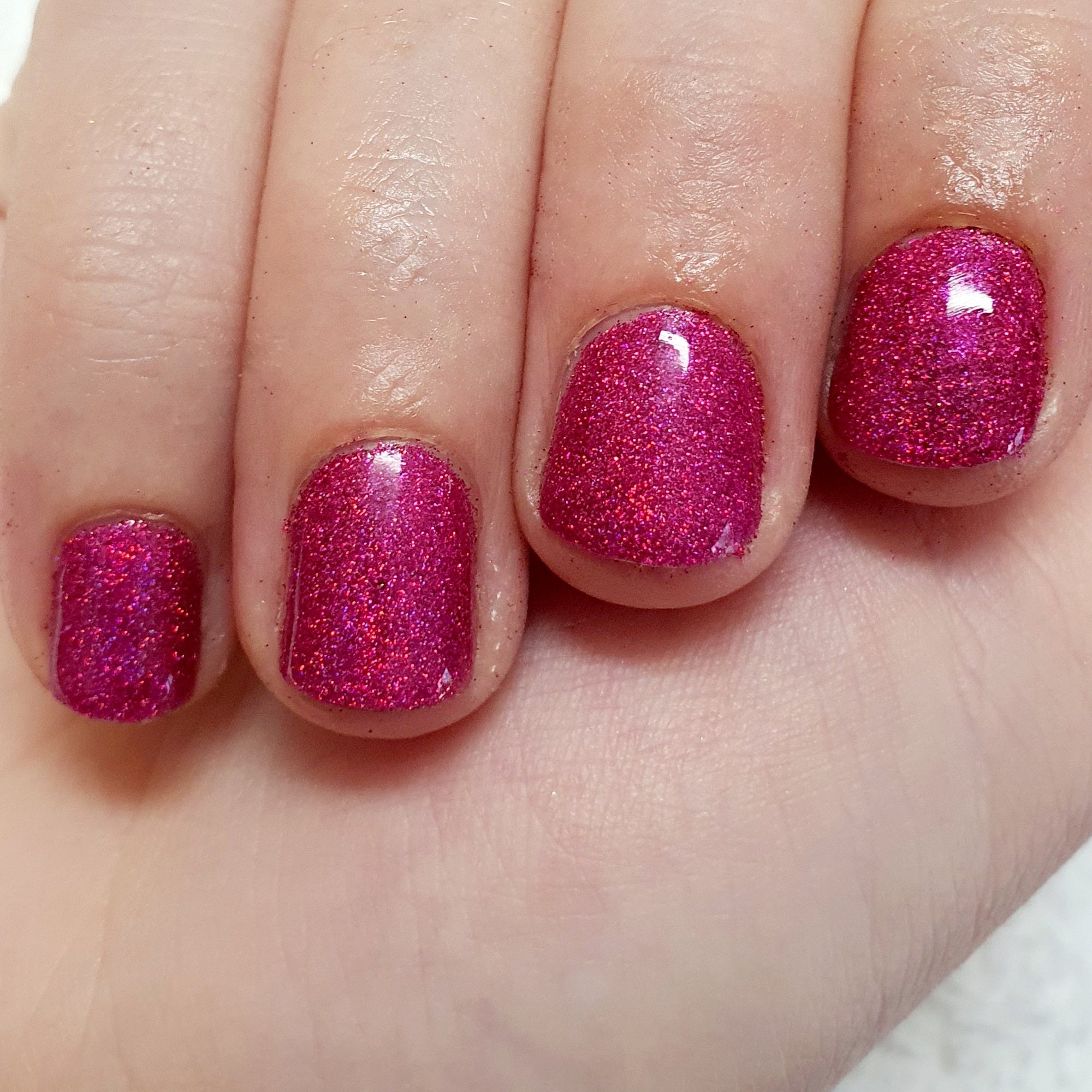Hot pink holographic glitter manicure.